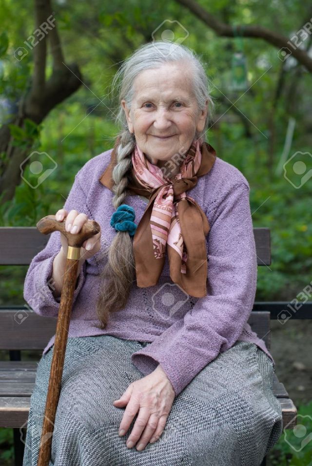 20110747-vecchia-nonna-con-una-lunga-treccia-in-estate-in-giardino-Archivio-Fotografico